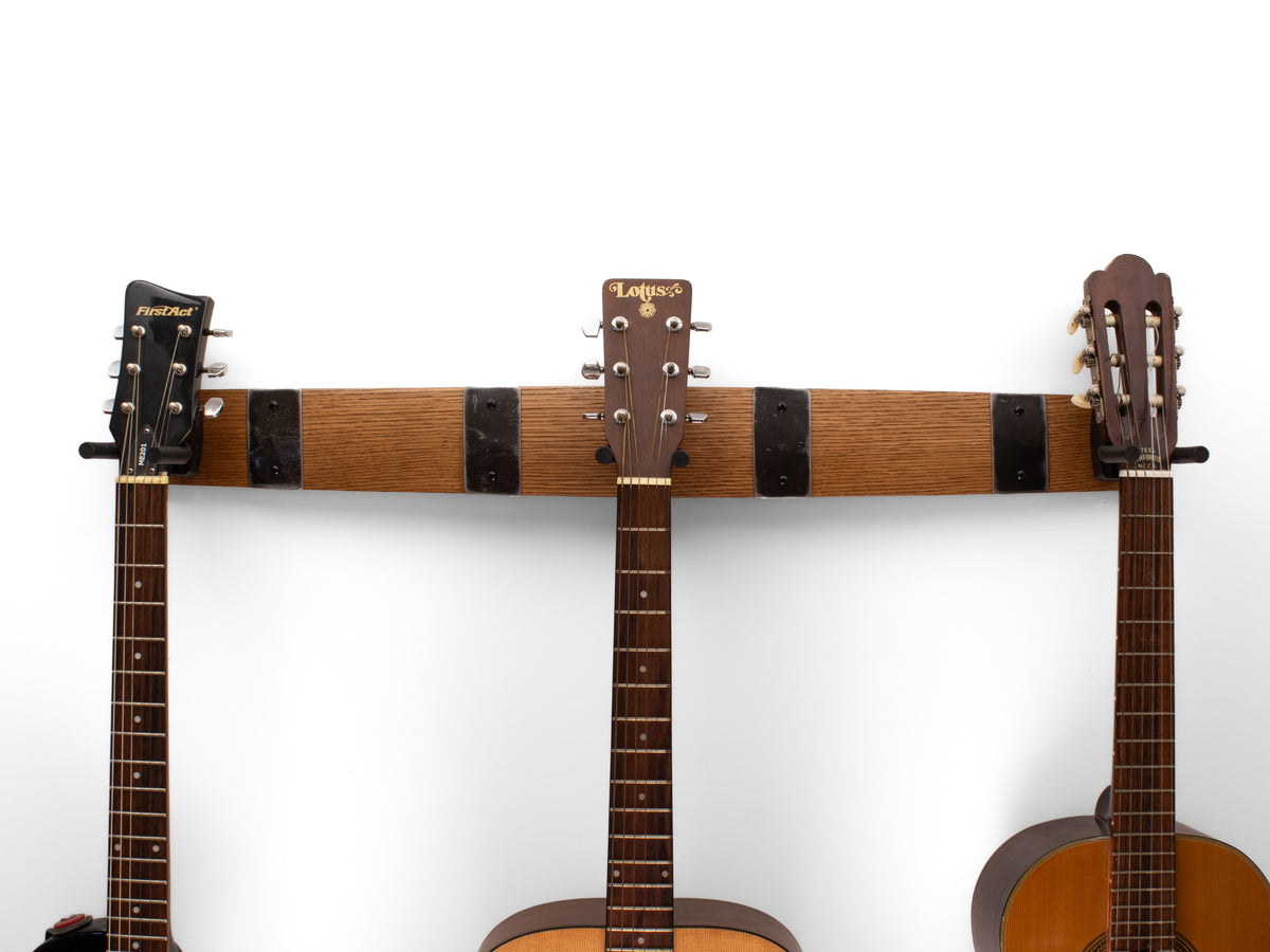 Early American finish 36-inch whiskey barrel stave triple guitar hanger with four barrel hoop accents holding three guitars